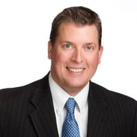 Business professional headshot of a man in a suit and tie